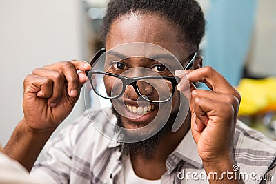 Happy male fashion designer holding eye glasses Stock Photo