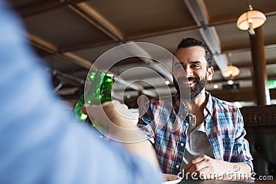 Happy male friends drinking beer at bar or pub Stock Photo