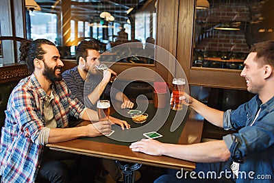 Happy male friends drinking beer at bar or pub Stock Photo