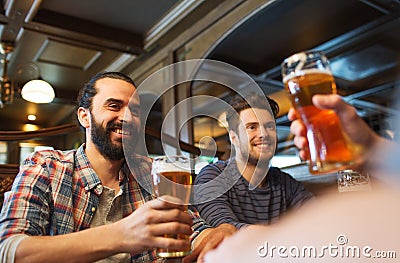 Happy male friends drinking beer at bar or pub Stock Photo