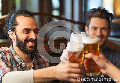 Happy male friends drinking beer at bar or pub Stock Photo