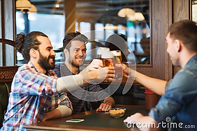 Happy male friends drinking beer at bar or pub Stock Photo