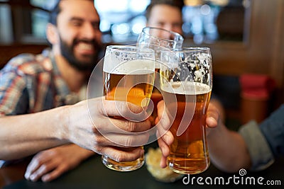 Happy male friends drinking beer at bar or pub Stock Photo