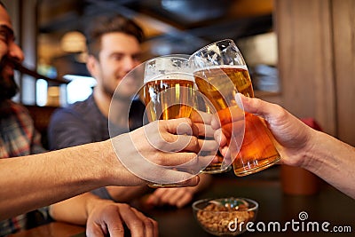 Happy male friends drinking beer at bar or pub Stock Photo