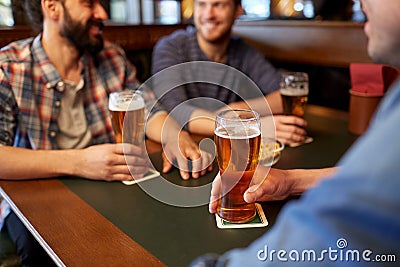 Happy male friends drinking beer at bar or pub Stock Photo