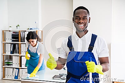Happy Male Janitor In Office Stock Photo