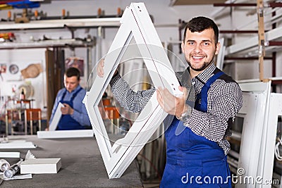 happy male professional labours with finished PVC profiles and windows Stock Photo