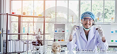A happy male scientist showing the successful results of his experiment in a science lab Stock Photo
