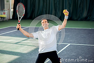 Happy male tennis player became a winner Stock Photo