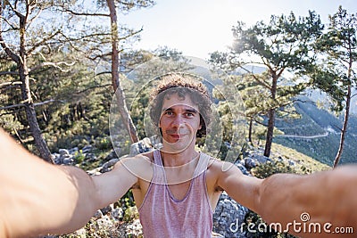 Happy male tourist takes a selfie in the forest. A man takes a selfie on the street. An influential travel blogger enjoys a trip Stock Photo