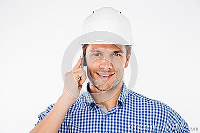 Happy man building engineer in helmet talking on mobile phone Stock Photo