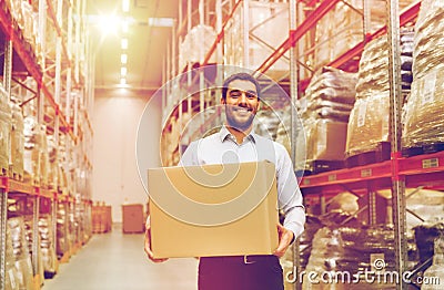 Happy man with cardboard parcel box at warehouse Stock Photo