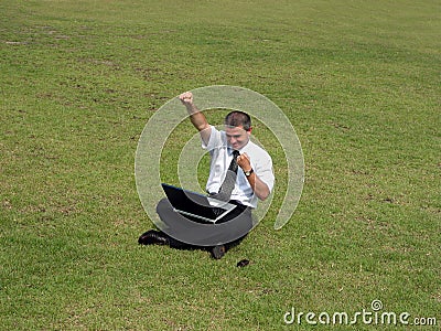 Happy man with computer in the field Stock Photo