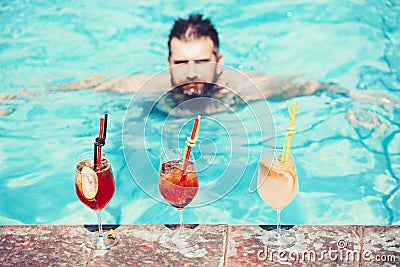 Happy man drink cocktail at the pool. Summer holiday idyllic Stock Photo