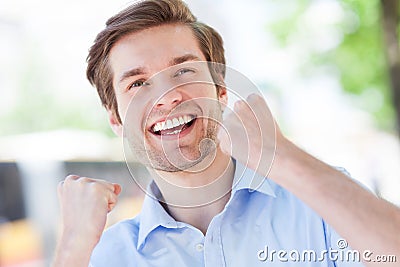 Happy man with fists clenched Stock Photo