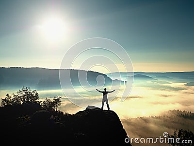 Happy man gesture of triumph with hands in the air. Funny hiker with raised arm Stock Photo