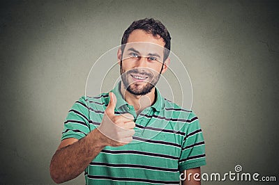 Happy man giving thumbs up sign. Positive human face expression body language Stock Photo
