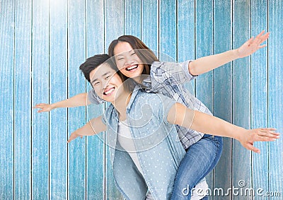 Happy man giving woman piggyback Stock Photo