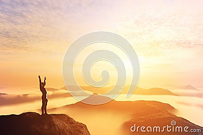 Happy man with hands up on the top of the world above clouds. Bright future Stock Photo