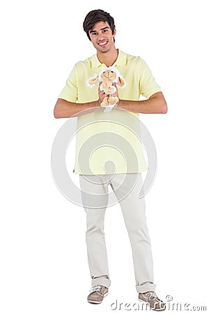 Happy man holding a sheep plush Stock Photo