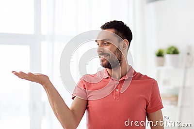 Happy man holding something imaginary at home Stock Photo