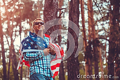 Happy man holding USA flag. Celebrating Independence Day of America. July 4th. Man having fun Stock Photo