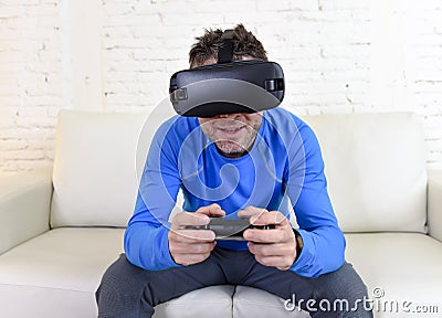 Happy man at home living room sofa couch excited using 3d goggles watching 360 virtual reality Stock Photo