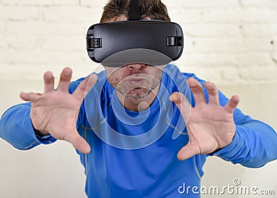 Happy man at home living room sofa couch excited using 3d goggles watching 360 virtual reality Stock Photo