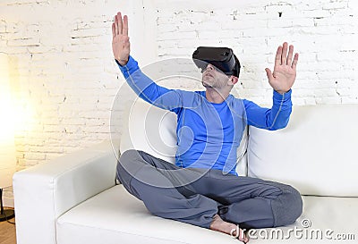 Happy man at home living room sofa couch excited using 3d goggles watching 360 virtual reality Stock Photo