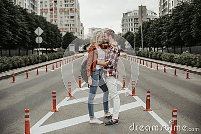 Happy man hugging his beloved woman at street Stock Photo