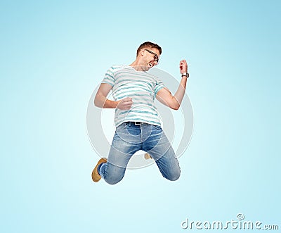 Happy man jumping and playing imaginary guitar Stock Photo