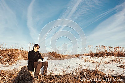 Happy man with laptop in the wheat field. Stock Photo