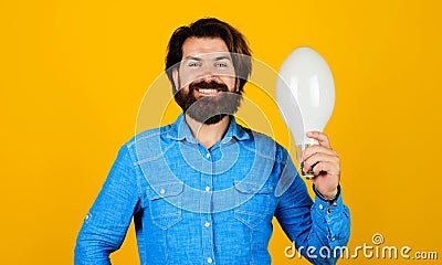 Happy man with light bulb. Bearded man with lamp. Good idea. Lightbulb in hand. Energy, electricity. Stock Photo
