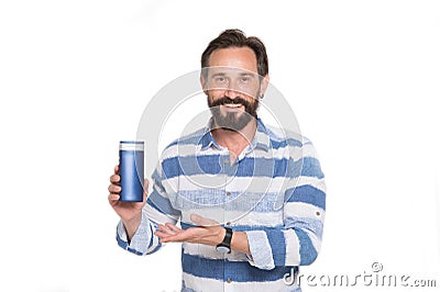 Happy man pointing to the bottle of shampoo and smiling Stock Photo