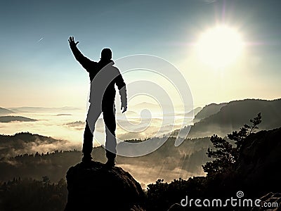 Happy man with raised arms gesture triumph on exposed cliff. Satisfy hiker Stock Photo