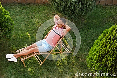 Man resting in deck chair outdoors, above view Stock Photo