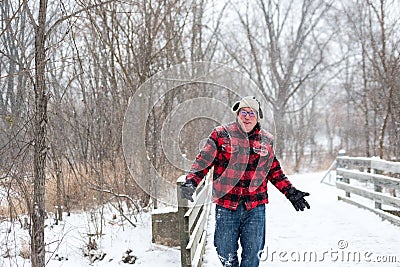 Happy man in plaid playing in the snow Stock Photo