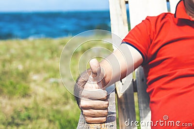 Happy man showing thumbs up while relaxing Stock Photo