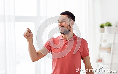 Happy man touching something imaginary at home Stock Photo