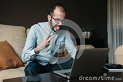 Happy man videoconferencing and having fun at home Stock Photo