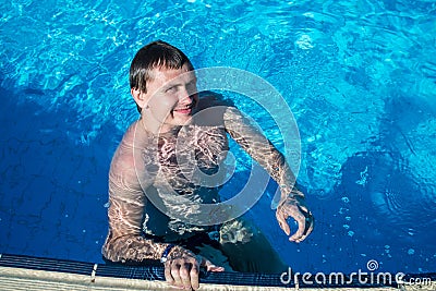 Happy man in water near swimming-pool nosing Stock Photo