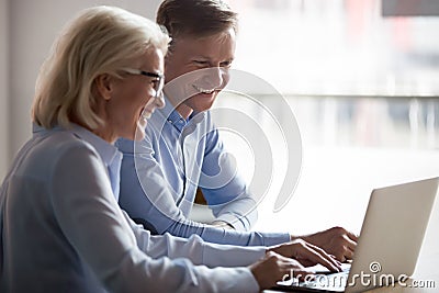 Happy manager and client having conversation at meeting with laptop Stock Photo