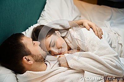 Happy married couple dozing in each others arms Stock Photo