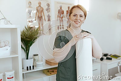 happy massage therapist woman in massage cabinet Stock Photo