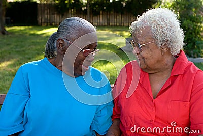 Happy mature African American sisters laughing and smiling. Stock Photo