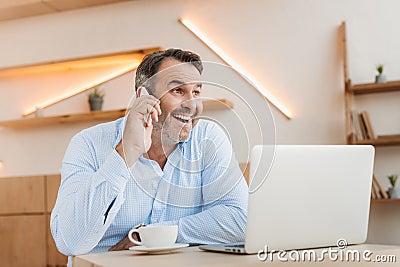 happy businessman talking by phone in cafe Stock Photo