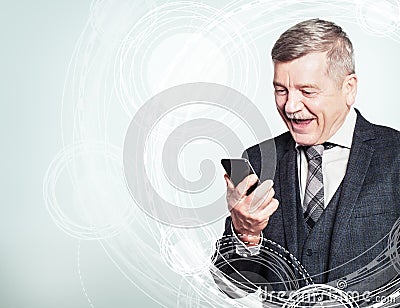 Happy mature businessman using a cell phone on high tech background Stock Photo