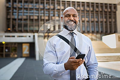 Happy mature businessman using phone Stock Photo