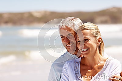 Happy mature couple embracing at the beach Stock Photo