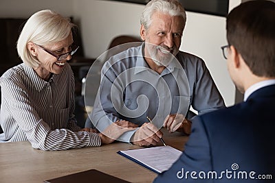 Happy mature family couple of clients consulting legal expert Stock Photo